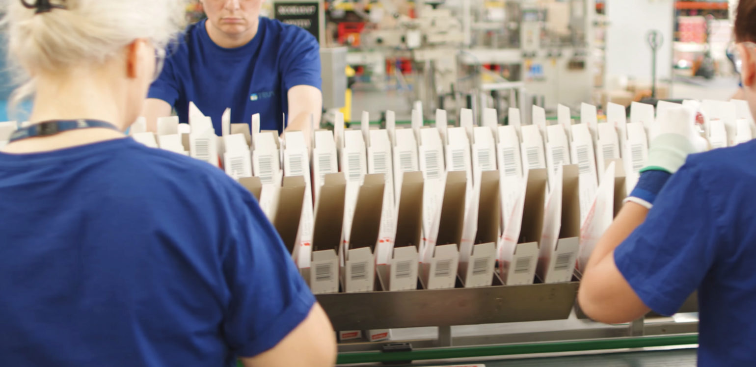 workers on packaging assembly line