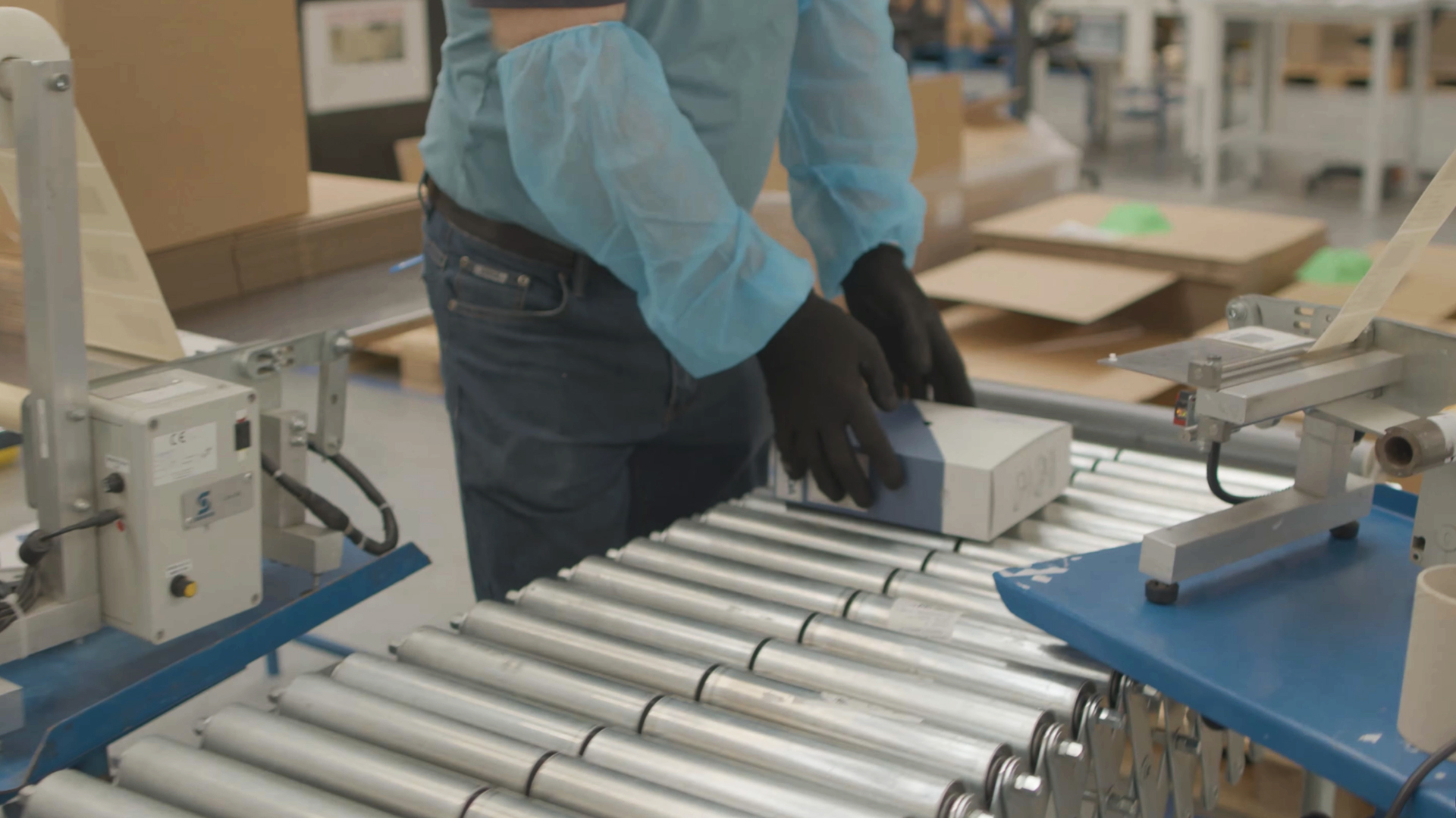 worker on packaging assembly line